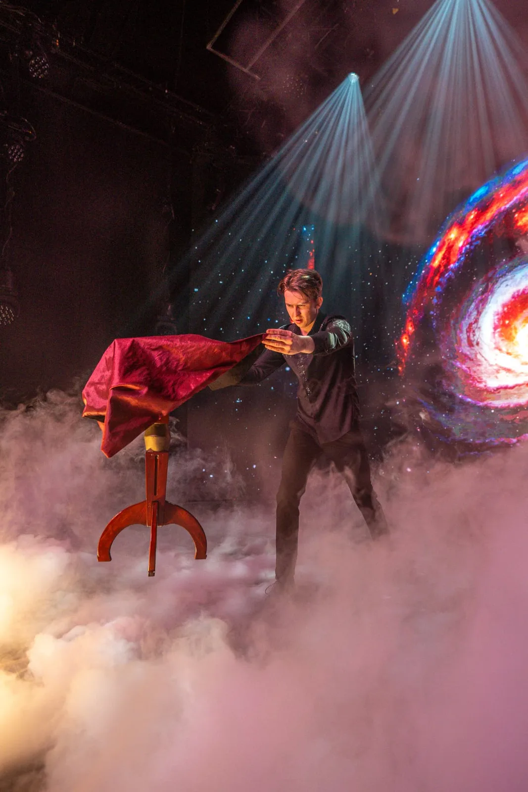 Illusionist Nigel Otermans performing a levitation in stage smoke